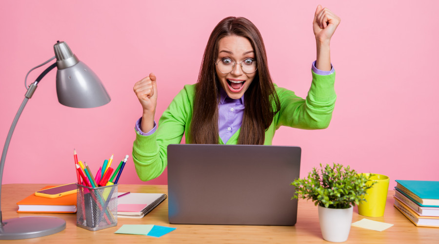 photo-excited-girl-sit-table-laptop-win-raise-fists-scream-wear-green-shirt-isolated-pastel-color-background-w900px